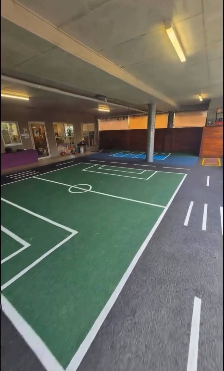 Green wet pour rubber indoor multi-sport and futsal court with white line markings